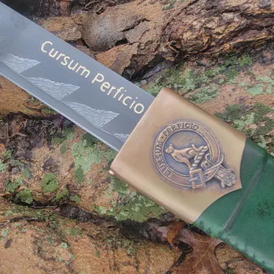 Finished brass guard, green leather grip, and emerald pommel